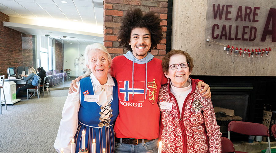 Augsburg Associates and a student dressed in their traditional Norwegian atire